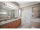 Bathroom featuring dual sinks, a soaking tub, and a separate walk-in shower at 826 Addison Ne Dr, St Petersburg, FL 33716