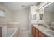 Bathroom with a soaking tub and dual sinks providing a functional layout at 826 Addison Ne Dr, St Petersburg, FL 33716