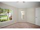 Bright bedroom featuring neutral walls, carpet flooring, and large windows with a view at 826 Addison Ne Dr, St Petersburg, FL 33716