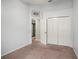 Comfortable bedroom with neutral walls, plush carpet, closet, and natural light at 826 Addison Ne Dr, St Petersburg, FL 33716