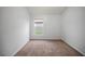 Comfortable bedroom features neutral walls, plush carpet, and a window for natural light at 826 Addison Ne Dr, St Petersburg, FL 33716