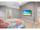 Bedroom with a view of an en suite bathroom and a wall-mounted television at 826 Addison Ne Dr, St Petersburg, FL 33716
