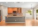 Kitchen with gray island, stainless steel fridge, and wooden cabinets at 826 Addison Ne Dr, St Petersburg, FL 33716