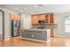 Kitchen with gray island, stainless steel fridge, and wooden cabinets at 826 Addison Ne Dr, St Petersburg, FL 33716