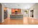 Kitchen with gray island, stainless steel fridge, and wooden cabinets at 826 Addison Ne Dr, St Petersburg, FL 33716