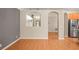 Open living room with hardwood floors, neutral walls, arched doorways, and kitchen access at 826 Addison Ne Dr, St Petersburg, FL 33716