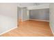 Spacious living room featuring light wood floors and neutral gray accent wall at 826 Addison Ne Dr, St Petersburg, FL 33716