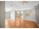 Open-concept living room with hardwood floors, neutral walls, and arched doorways at 826 Addison Ne Dr, St Petersburg, FL 33716