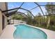 Beautiful screened-in pool area with a clear view of the lush backyard and clear blue water at 826 Addison Ne Dr, St Petersburg, FL 33716