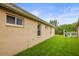 Side yard features green grass and a white privacy fence leading to the backyard at 826 Addison Ne Dr, St Petersburg, FL 33716