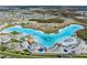 Stunning aerial view of the lagoon with clear blue water and various recreational amenities at 8310 Hardy Bay Loop, Wesley Chapel, FL 33545