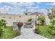 Picturesque backyard featuring a cozy fire pit area with stone accents and lush landscaping at 8310 Hardy Bay Loop, Wesley Chapel, FL 33545
