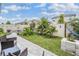 Landscaped backyard featuring a fire pit, hammock, and outdoor seating creating a relaxing oasis at 8310 Hardy Bay Loop, Wesley Chapel, FL 33545