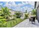 Serene backyard showcasing a hammock, stone fire pit, and a peaceful seating area amidst lush greenery at 8310 Hardy Bay Loop, Wesley Chapel, FL 33545