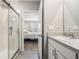Bathroom showcasing a glass-enclosed shower and vanity, leading to the Primary bedroom at 8310 Hardy Bay Loop, Wesley Chapel, FL 33545