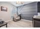 Office space with stylish accent wall, light gray walls and a comfortable chair at 8310 Hardy Bay Loop, Wesley Chapel, FL 33545