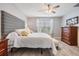 Serene bedroom with a decorative headboard, stylish furnishings, and light-filled windows at 8310 Hardy Bay Loop, Wesley Chapel, FL 33545