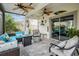 Relaxing covered patio with stylish furniture, ceiling fans, and a seamless transition to the backyard at 8310 Hardy Bay Loop, Wesley Chapel, FL 33545