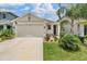 Charming single-Gathering home showcasing a well-manicured lawn and a two-car garage on a sunny day at 8310 Hardy Bay Loop, Wesley Chapel, FL 33545
