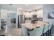 Modern kitchen with stainless steel appliances, granite countertops, and breakfast bar at 8310 Hardy Bay Loop, Wesley Chapel, FL 33545