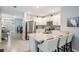 Modern kitchen with stainless steel appliances, granite countertops, and breakfast bar at 8310 Hardy Bay Loop, Wesley Chapel, FL 33545