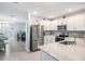 Modern kitchen with stainless steel appliances, granite countertops, and breakfast bar at 8310 Hardy Bay Loop, Wesley Chapel, FL 33545