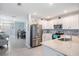 Modern kitchen with stainless steel appliances, granite countertops, and backsplash at 8310 Hardy Bay Loop, Wesley Chapel, FL 33545