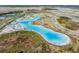 Aerial view of the lagoon showcasing the pristine blue water and the recreational amenities it offers in the Epperson community at 8310 Hardy Bay Loop, Wesley Chapel, FL 33545