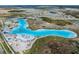 Aerial view of the lagoon featuring clear blue water, sandy beach, and watersport activities in the Epperson community at 8310 Hardy Bay Loop, Wesley Chapel, FL 33545