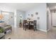 Cozy living room with neutral tile flooring and a decorative dining table set at 8310 Hardy Bay Loop, Wesley Chapel, FL 33545