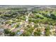 See an aerial view of the property, surrounded by trees and other homes in a suburban neighborhood at 8499 101St Ave, Seminole, FL 33777