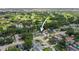 This aerial view showcases a charming home nestled near a lush golf course, promising serene living at 8499 101St Ave, Seminole, FL 33777