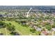 Aerial view of a property nestled among lush trees and near a serene pond and golf course at 8499 101St Ave, Seminole, FL 33777