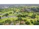 Stunning aerial view of the golf course and neighborhood, featuring lush greenery and serene ponds at 8499 101St Ave, Seminole, FL 33777