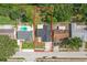 Aerial view highlighting a house with a well-kept yard, framed by neighboring properties and a clean street at 8499 101St Ave, Seminole, FL 33777