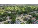 Aerial view of a neighborhood with houses surrounded by trees with a golf course in the background at 8499 101St Ave, Seminole, FL 33777