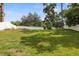 This is a spacious backyard with green grass and a white privacy fence, perfect for outdoor activities at 8499 101St Ave, Seminole, FL 33777
