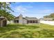 Picture of the expansive backyard featuring healthy grass, a storage shed, and a white privacy fence at 8499 101St Ave, Seminole, FL 33777