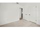 Bright bedroom with neutral carpet, closet, and connecting hallway at 8499 101St Ave, Seminole, FL 33777