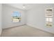 Bright bedroom with two windows and neutral carpet at 8499 101St Ave, Seminole, FL 33777