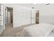 Bright bedroom features plush carpet, white walls, closet, and ensuite bathroom for modern comfort at 8499 101St Ave, Seminole, FL 33777