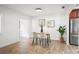 Dining area with wood floors, stainless steel refrigerator and modern furnishings at 8499 101St Ave, Seminole, FL 33777