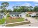 Charming home featuring a well-maintained front yard with meticulous landscaping and an attached garage at 8499 101St Ave, Seminole, FL 33777
