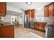 Kitchen featuring stainless steel appliances, granite countertops, and wood cabinets at 8499 101St Ave, Seminole, FL 33777