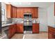 Kitchen featuring stainless steel appliances, granite countertops, and wood cabinets at 8499 101St Ave, Seminole, FL 33777