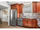 Updated kitchen with stainless steel appliances and dark wood cabinetry at 8499 101St Ave, Seminole, FL 33777