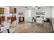 Open-concept living space with wood floors, neutral furniture, and a view of the kitchen and dining area at 8499 101St Ave, Seminole, FL 33777