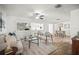 Bright living room featuring wood floors, neutral furniture, ceiling fan, and open layout to dining area at 8499 101St Ave, Seminole, FL 33777