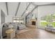 Bright living room with vaulted ceiling, fireplace, wood floors, and large windows at 8499 101St Ave, Seminole, FL 33777