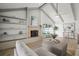 Bright living room features fireplace, vaulted ceiling, wood floors, and built-in shelving at 8499 101St Ave, Seminole, FL 33777